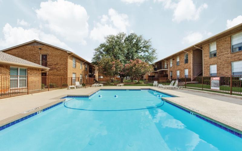 a swimming pool with buildings surrounding it