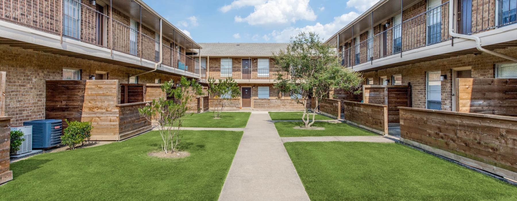 a building with a green lawn