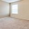 a room with a carpet and a window
